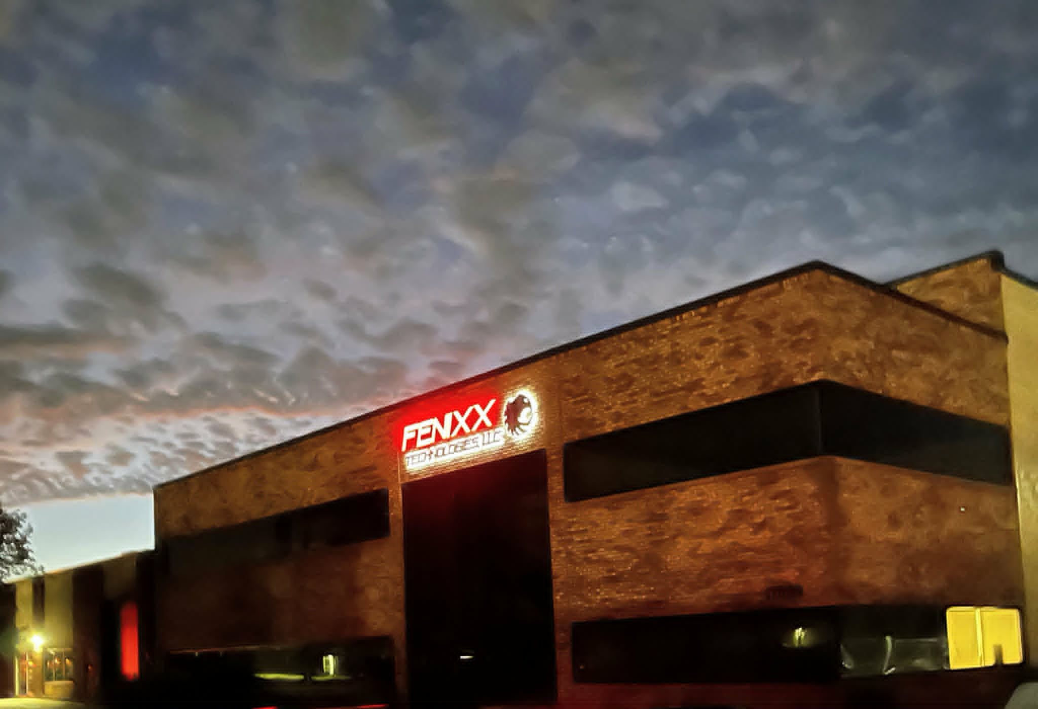 Fenixx Technologies facility at night with illuminated sign